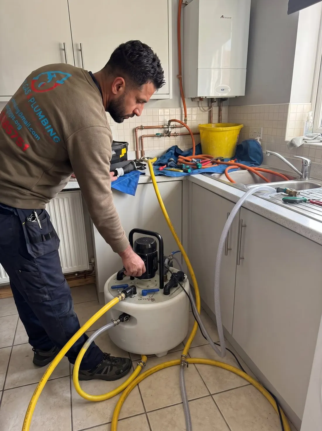 Synergy Gas & Plumbing engineer carrying out a power flush